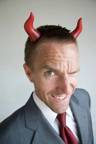 Photo of Devilish Horny Businessman With Mischief in His Eyes