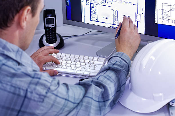 istock Construction manager checks the building plans on the computer. 182177029