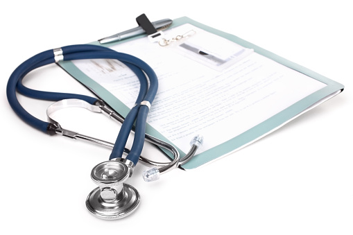 Stethoscope and a report isolated over white background