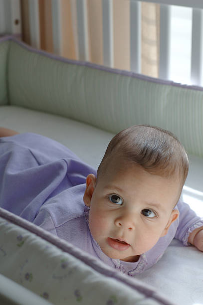 istock baby in crib looking up 182177467