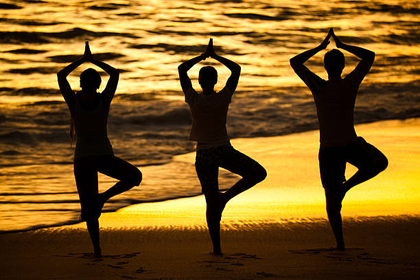 istock yoga on beach at sunset 182177478