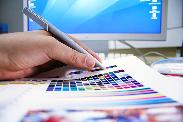 istock Graphic designer checks the colors on the printed page 182177633