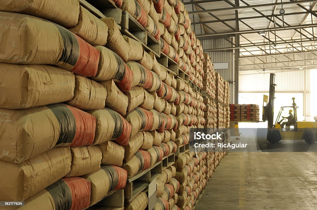 Warehouse full of sacks stacked from floor to ceiling warehouse, sacks and pallet Cement Stock Photo