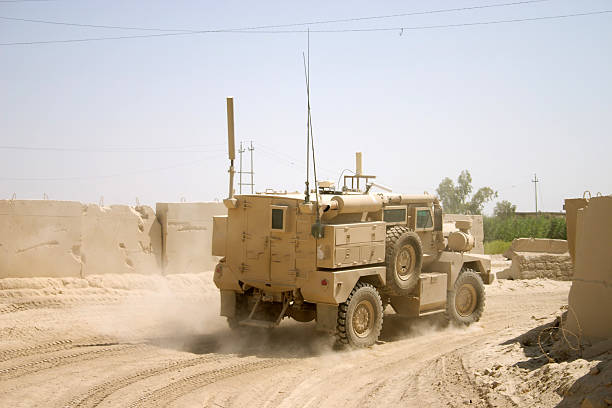 IED Truck A Specialized anti-IED U.S. truck goes on patrol. armored vehicle stock pictures, royalty-free photos & images