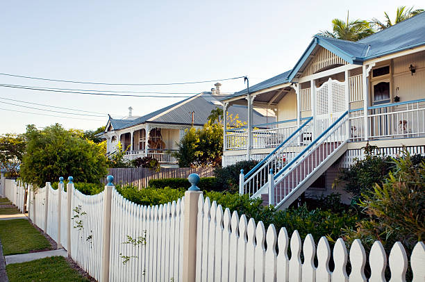 Streetscape in Queensland "Typical restored traditional domestic architecture in Brisbane, Australia. These types of houses are known as 'Queenslanders' and are built up off the ground because of the tropical climate." queensland stock pictures, royalty-free photos & images