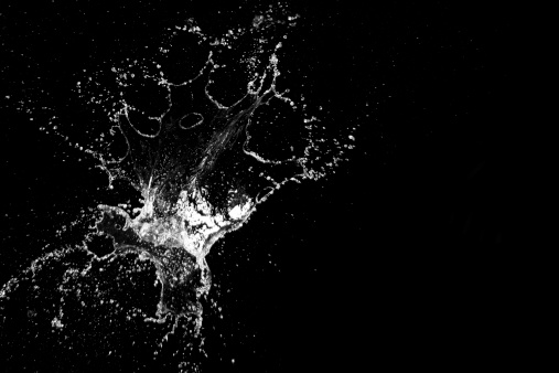 Water exploding on a black background.Some blur due to velocity of the water.