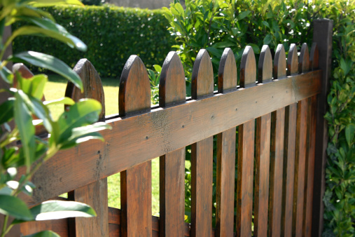 Brown wooden board fence with fence posts, Germany