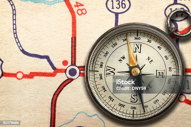 Compass Sitting On Top Of Road Map Showing Highway Junction Stock Photo - Download Image Now