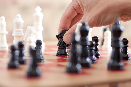 Chess moves on chess board. Shallow depth of field.