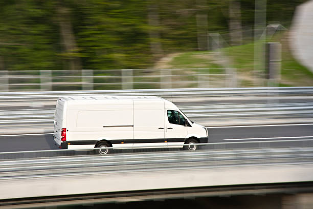 White delivery van White delivery van in speed on highway. car transporter photos stock pictures, royalty-free photos & images
