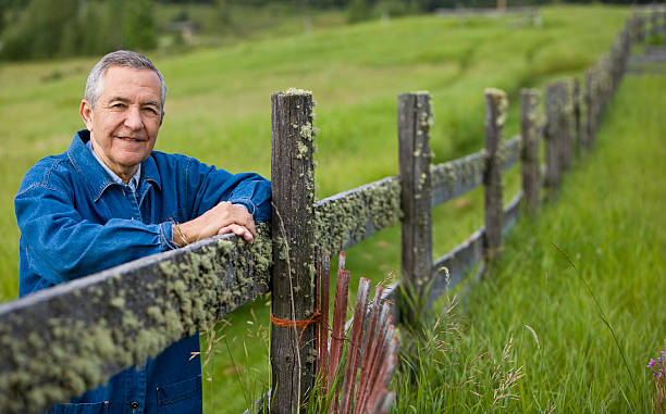 istock Senior man outdoors hands on wooden fence 182178856