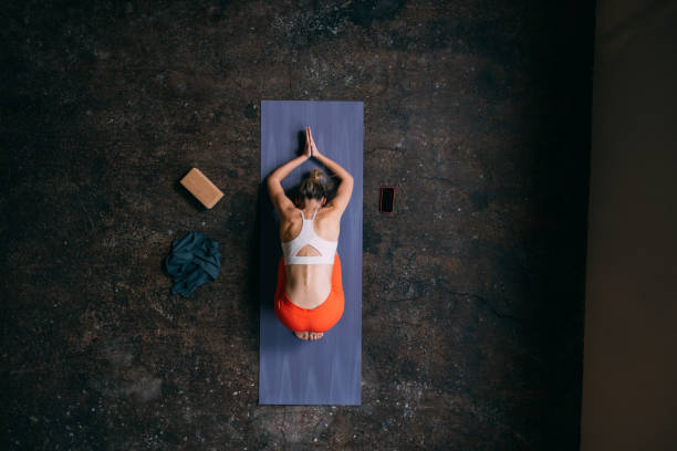 istock Body Harmony: Woman on Exercise Mat, Surrendering to the Stretch 1821793826