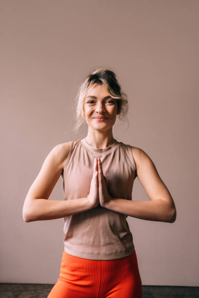 istock Namaste Strength: Woman Standing with Hands Clasped 1821794350