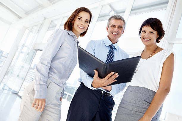 istock Smiling business people with folder 182179684
