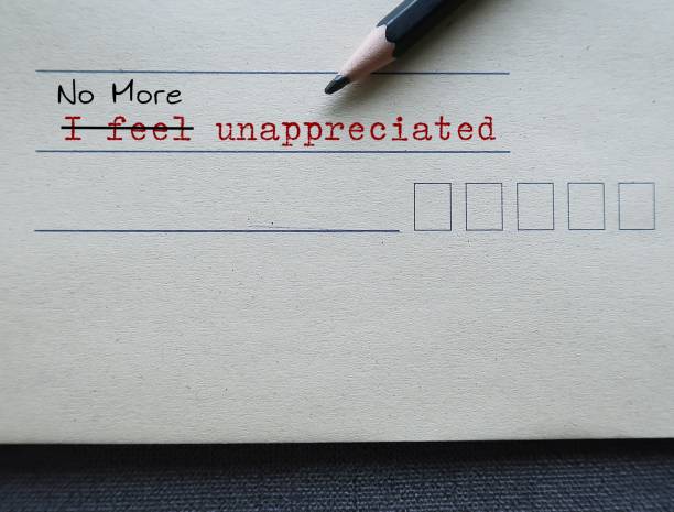 istock Office envelope with text written I FEEL UNAPPRECIATED changed to NO MORE UNAPPRECIATED - feeling undervalued when hard work and achievements go unnoticed or not recognized 1821796915