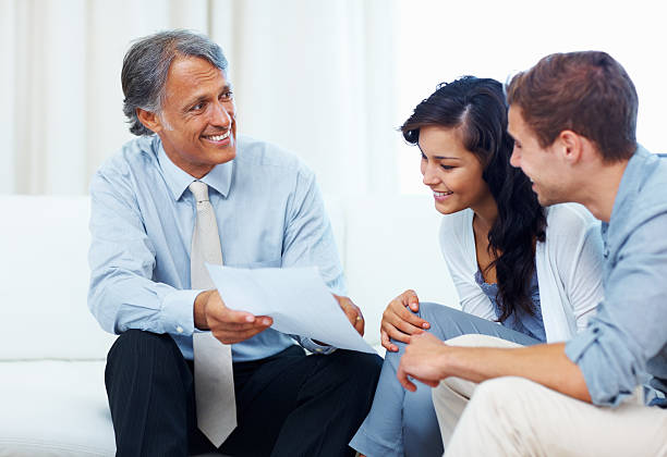 istock Couple discussing with a financial planner 182180331