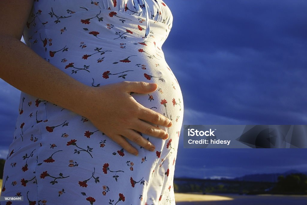 Movement Woman feeling baby kicking in pregnant belly Abdomen Stock Photo