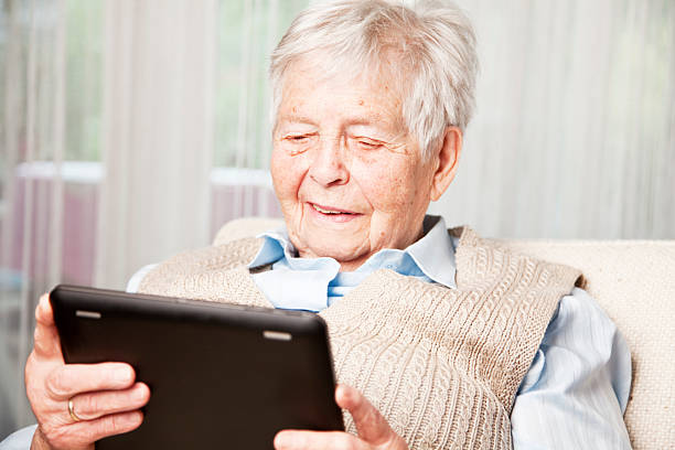 istock senior woman and digital tablet 182180722