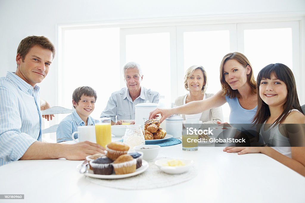 Retrato de família feliz de três generational tendo o pequeno-almoço - Royalty-free Comer Foto de stock