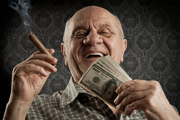 Old men Happy old man holding a big bundle of cash. mafia boss stock pictures, royalty-free photos & images