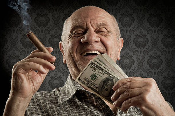 Old men Happy old man holding a big bundle of cash. man cigar stock pictures, royalty-free photos & images