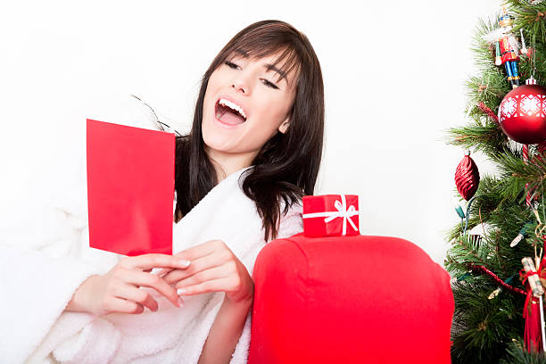 istock Smiling female reading christmas card 182181301