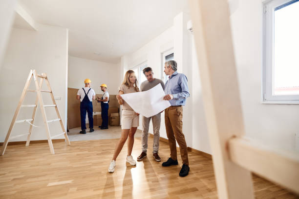 istock Couple working on plans with an architect during home renovation process. 1821819775