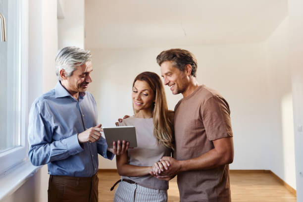 istock Happy interior designer using touchpad with his customers in the apartment. 1821825763