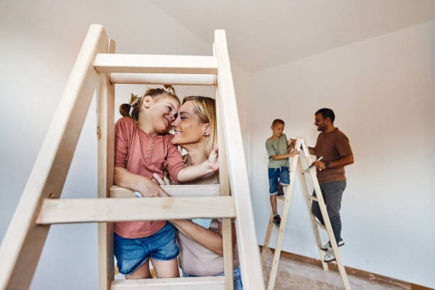 istock Loving mother and daughter on ladders during home renovation process. 1821827515