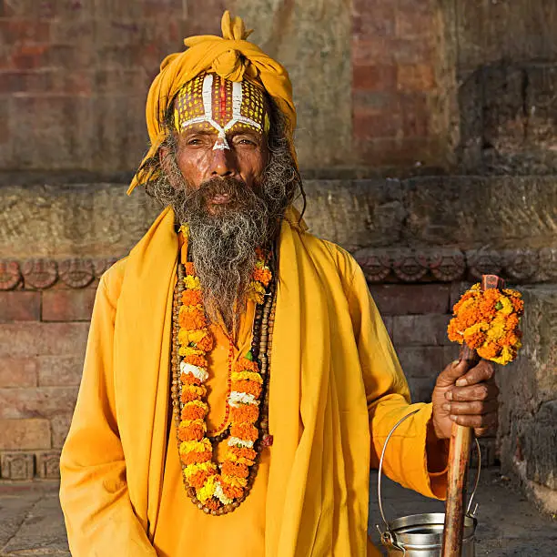 "In Hinduism, sadhu, or shadhu is a common term for a mystic, an ascetic, practitioner of yoga (yogi) and/or wandering monks. The sadhu is solely dedicated to achieving the fourth and final Hindu goal of life, moksha (liberation), through meditation and contemplation of Brahman. Sadhus often wear ochre-colored clothing, symbolizing renunciation."