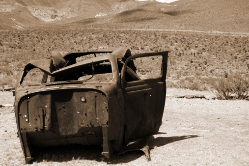 Abandoned old car on Route 66 in Arizona. Sepia