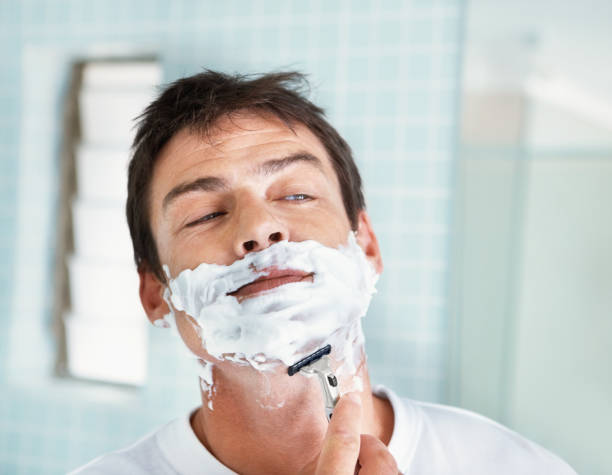 istock Middle aged man shaving in bathroom 182185165
