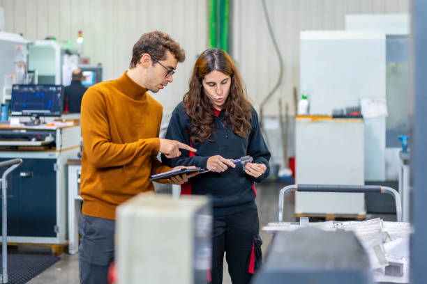 istock Quality control of two engineers using tablet in a cnc factory 1821859091