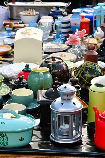 Women near table with different stuff indoors, closeup. Garage sale