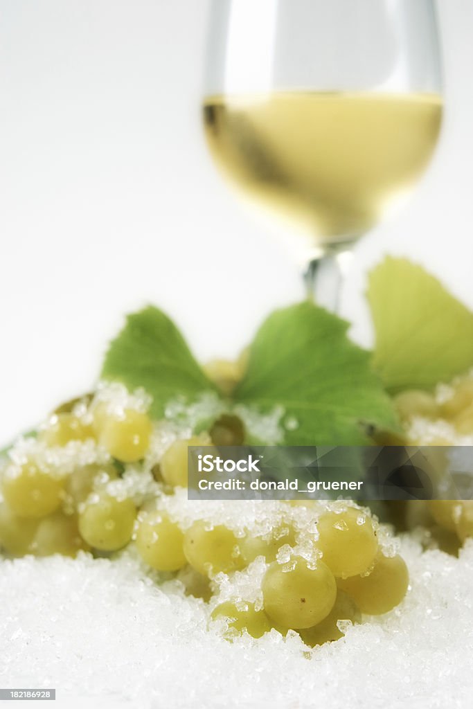 Ice Wine Ice wine with grapes & grapevine in icy snow. Shallow DOF with focus on nearest grapes & snow. Grape Stock Photo