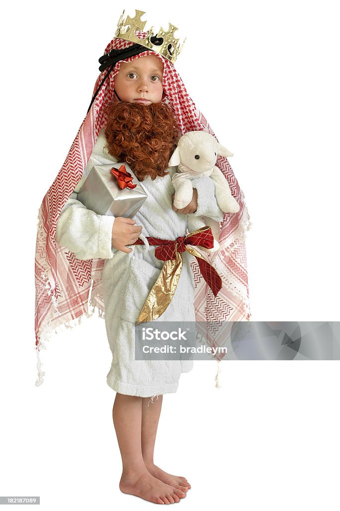 Nativity child A small child (7) dressed as a shepherd with a crown, present and toy lamb Child Stock Photo