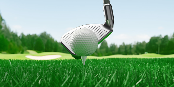 The putter is about to hit the ball. Large copy space on green grass. 3d rendered objects. Simple and clear design.