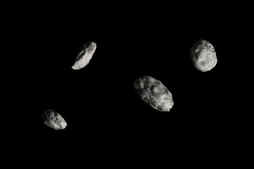 HiRes Rendering of four different Asteroids isolated on black background.