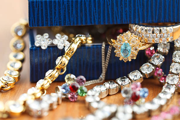 Jewelry box and pearl necklace, on wooden table.