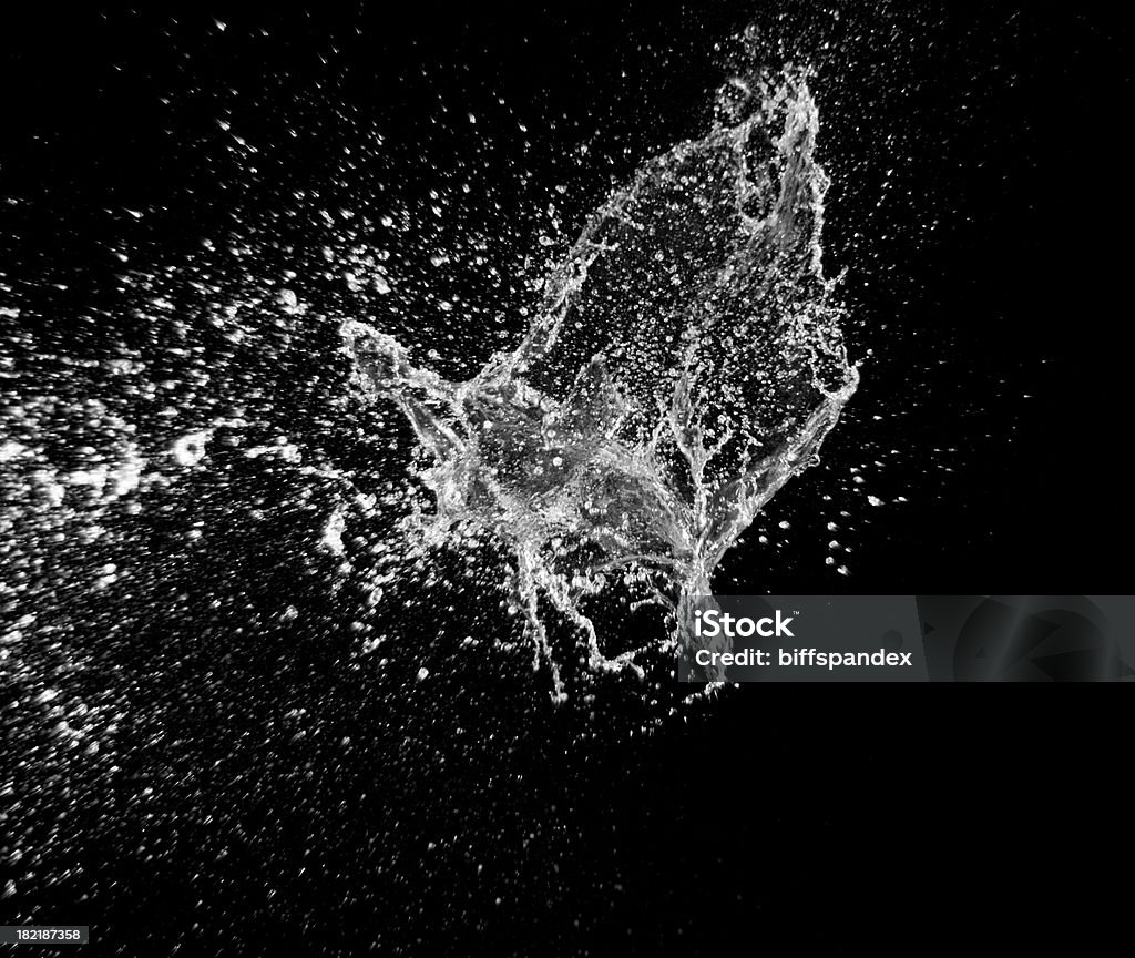 Exploding Water 2 Big splash of exploding water against a black background. Water Stock Photo