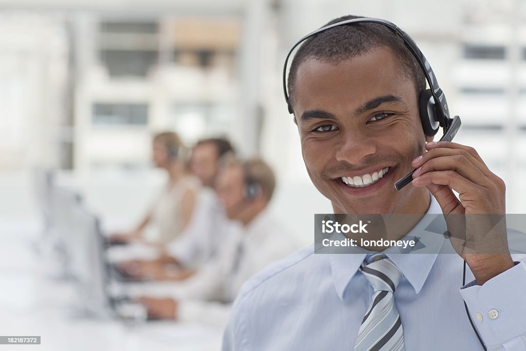 Happy customer service agent. Customer service agent in busy call center. Call Center Stock Photo