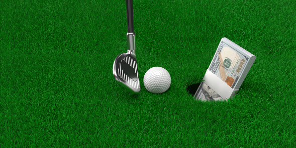 The bundle of dollars is in the golf hole. Concept of making money with golf game. Golf club stick and ball on the green grass. 3D rendered image. Large copy space.