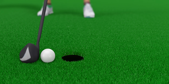 Golf player is about to hit the ball for a hole-in-one. The golf ball is right in front of the hole.
