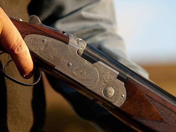 istock A close up of a man holding a shotgun 182187785