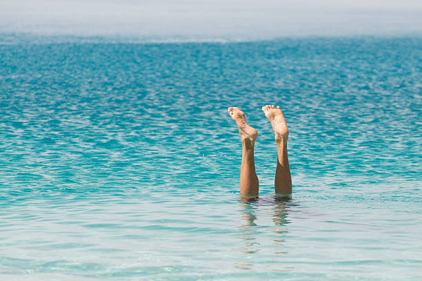 istock Feet Sticking Out of Blue Sea 182187798
