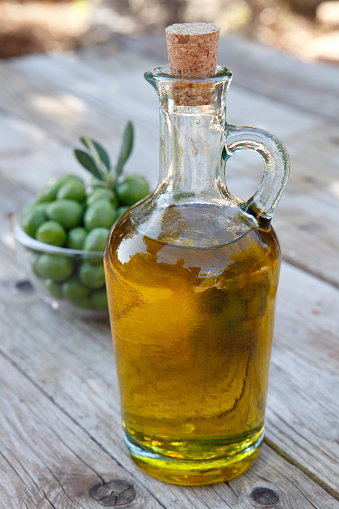 Olives and bottle with olive oil.