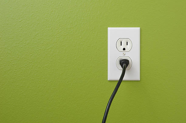 Wall Power Outlet Electrical power outlet against a green painted wall.related: electric plug stock pictures, royalty-free photos & images