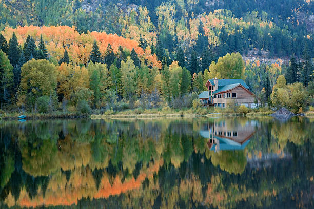 Lake House and Autumn Reflections "Cozy Cabin on Lake Purgatory in the fall.  San Juan National Forest area, Colorado .See all my SAN JUAN MTNS images:" log cabin photos stock pictures, royalty-free photos & images