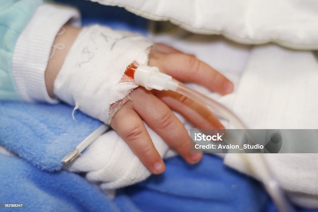 Child's hand connected a drip. Drip Baby - Human Age Stock Photo