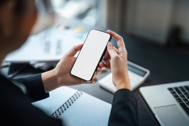 istock Business woman hand holding using mockup mobile phone with white blank screen for text, mobile app design and advertising, online marketing 1821883015
